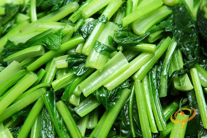 Close-up of fresh mustard greens from Florida Broadleaf seeds showing vibrant green leaves and stems